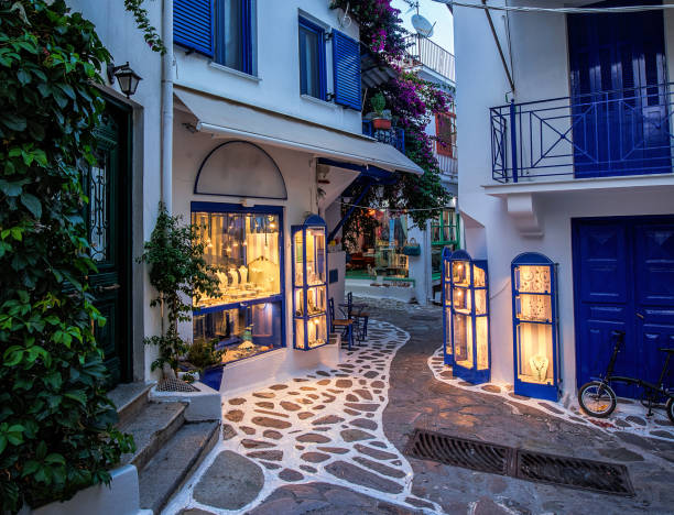 Beautiful old, narrow alley with cobblestone in Skiathos, Greece stock photo