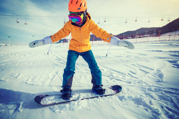 istock one young woman snowboarding in mountains 918893502