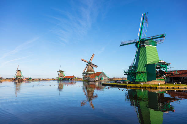 Traditional Dutch windmills at Zaanse Schans, Amsterdam, Netherland Zaanse Schans is a bucolic Dutch village with historical houses and working windmills near, Amsterdam, Netherland. zaanse schans stock pictures, royalty-free photos & images