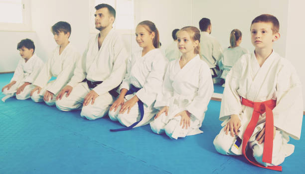 istock Happy children enjoying their trainings with coach at karate class 918897136