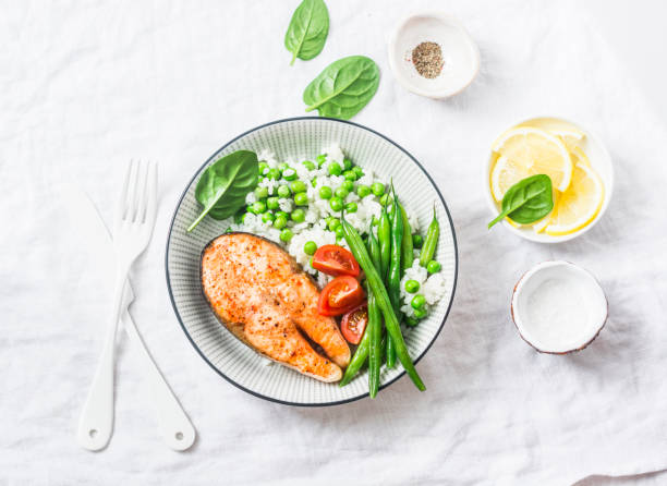 healthy balanced meal lunch plate - baked salmon with rice and vegetables on a light background, top view. - healthy eating food rice high angle view imagens e fotografias de stock