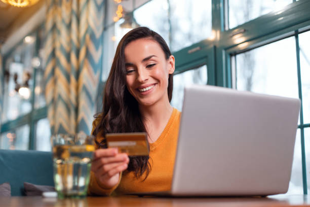 istock Irresistible positive woman using credit card 918898676