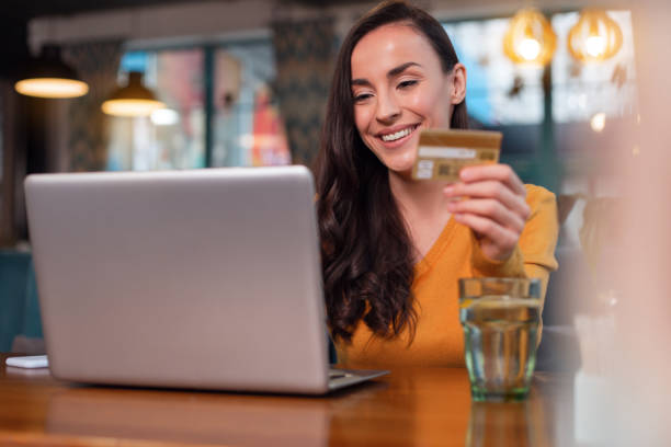 istock Cheerful glad woman making shopping online 918901220