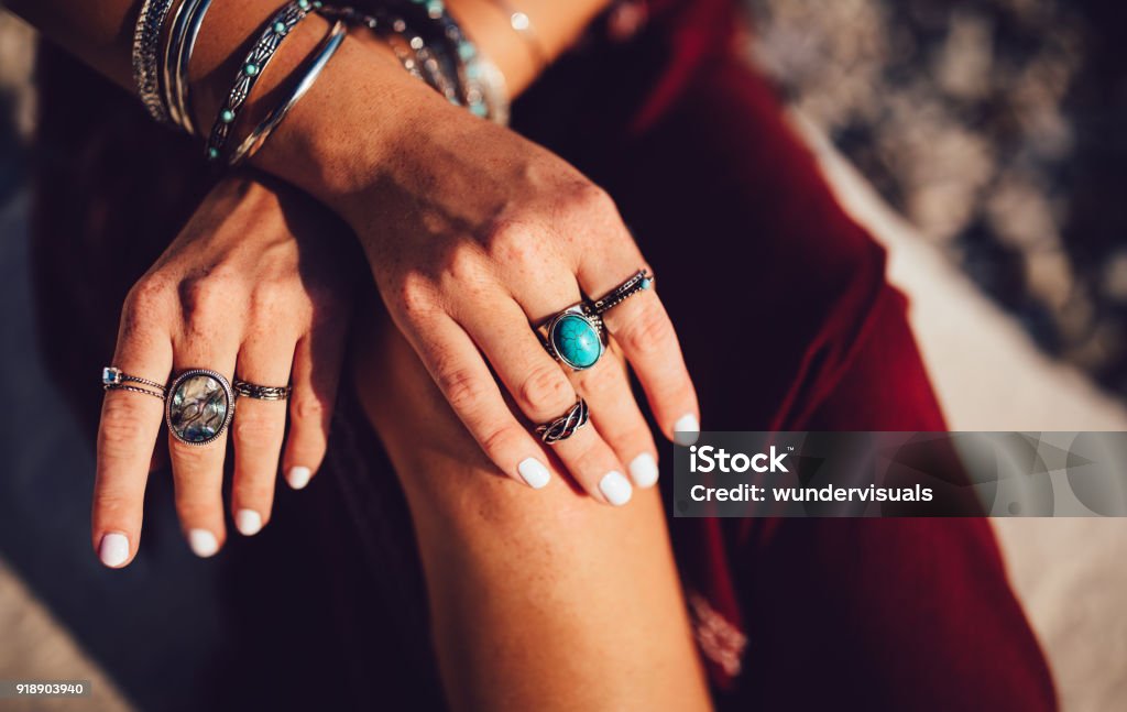 Close-up of bohemian woman's hands with silver jewelry Close-up of young woman's hands with freckles and boho style rings and bracelets Jewelry Stock Photo