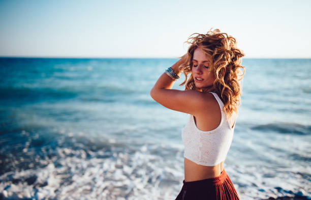 istock Beautiful redhead woman in boho style relaxing at the beach 918904500
