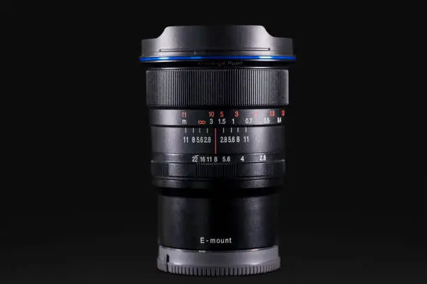 Side view of SLR camera lens with dark background in the studio