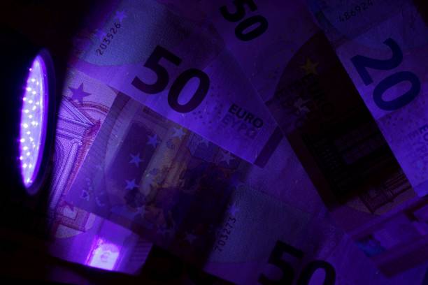 istock Banknotes in the beam of an UV light 918905736