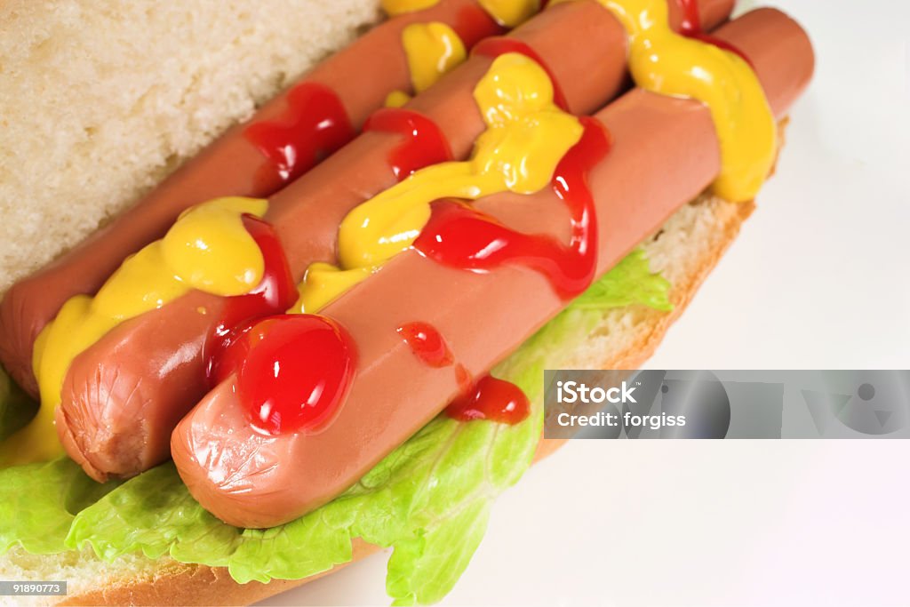 food A hot dog covered in tomato sauce and mustard on a white plate. Blank Stock Photo