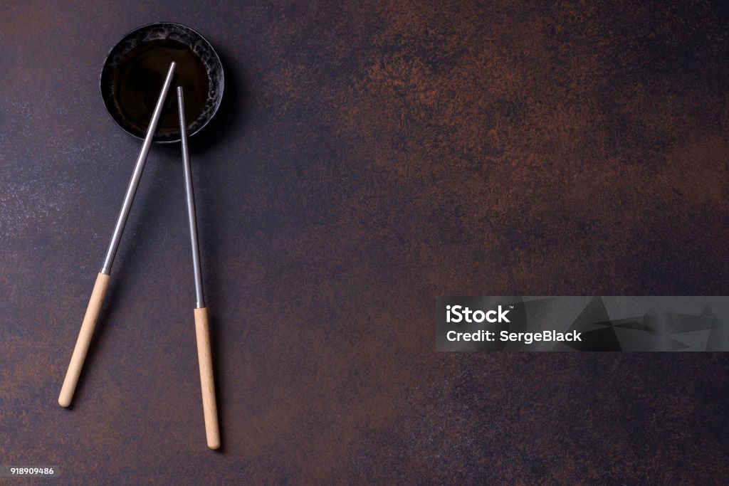 Two chopsticks and soy sauce for sushi Two chopsticks and soy sauce for sushi on brown background for menu Asia Stock Photo