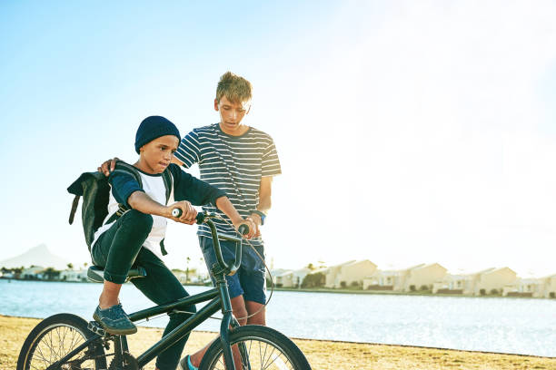 istock Teaching his brother how to ride a bike 918915530