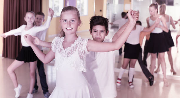 istock Group of  children dancing tango in dance studio 918918622