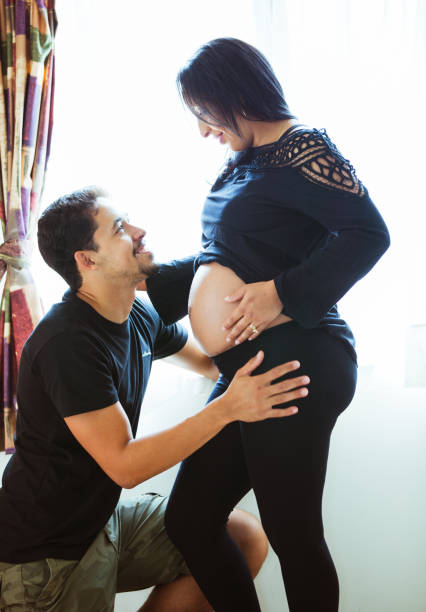 istock Man with affectionate face looking at his pregnant wife. 918933438