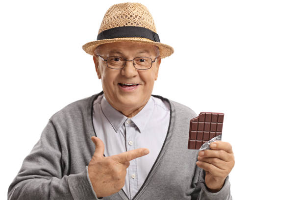istock Mature man holding a chocolate bar and pointing 918934002