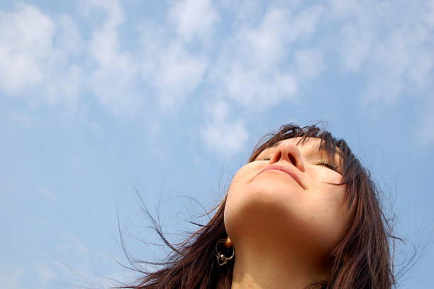 istock Young girl looking up against a blue sky 91893410