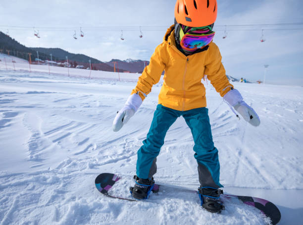 istock one young woman snowboarding in mountains 918934934