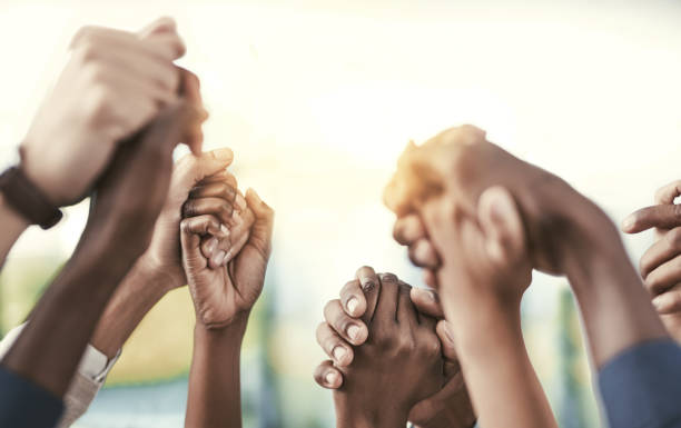 Good teams become great ones when they support each other Cropped shot of a group of businesspeople holding their hands in solidarity Unity stock pictures, royalty-free photos & images