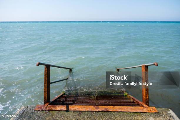 Rusty Metal Staircase Descends Into The Sea From The Pier Top View Stock Photo - Download Image Now