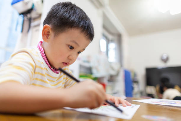 istock Child drawing pictures at home 918942444