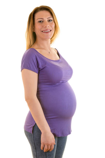 Red ribbon on a pregnant belly.