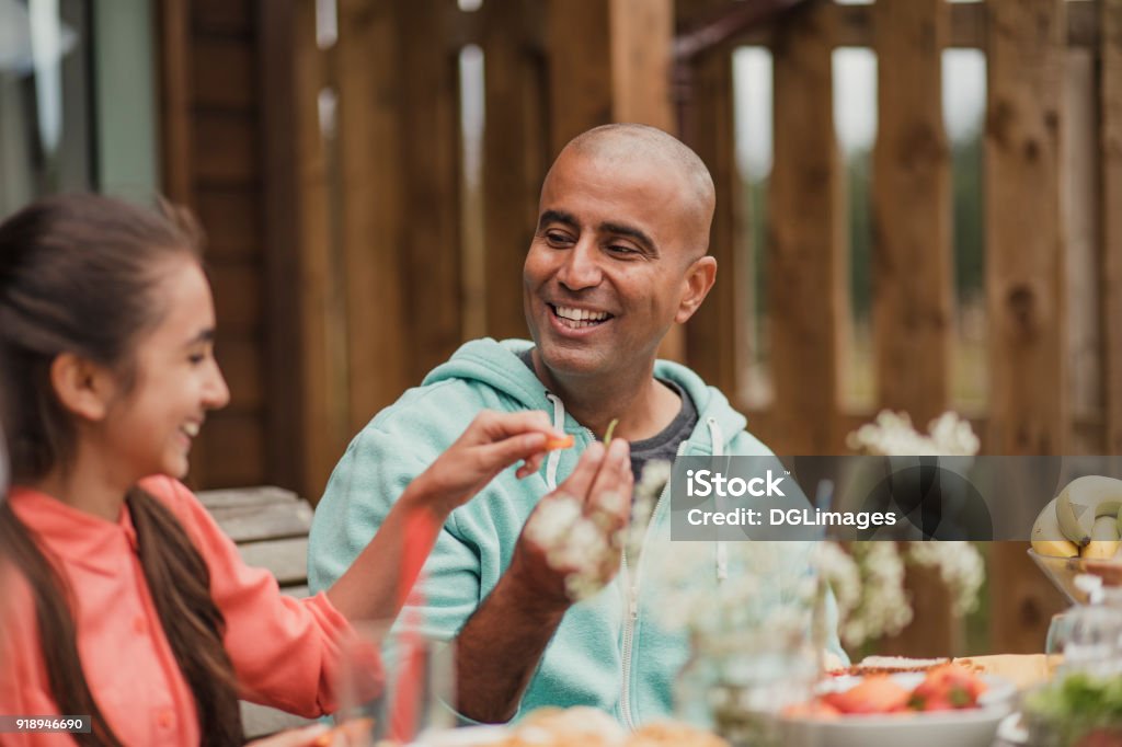 Bonding with Dad at Lunch Father bonding with daughter over lunch on holiday. Family Stock Photo