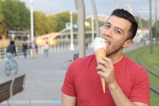 istock Man licking an ice cream with copyspace 918950690