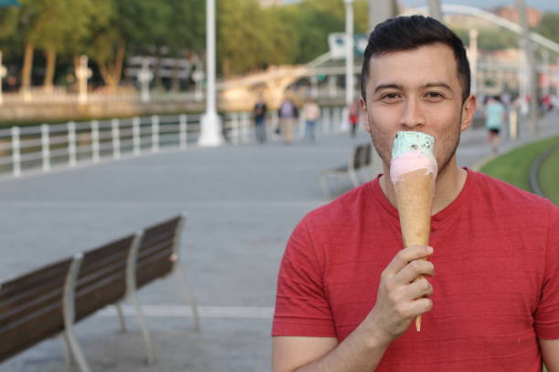 istock Man licking an ice cream with copyspace 918950710