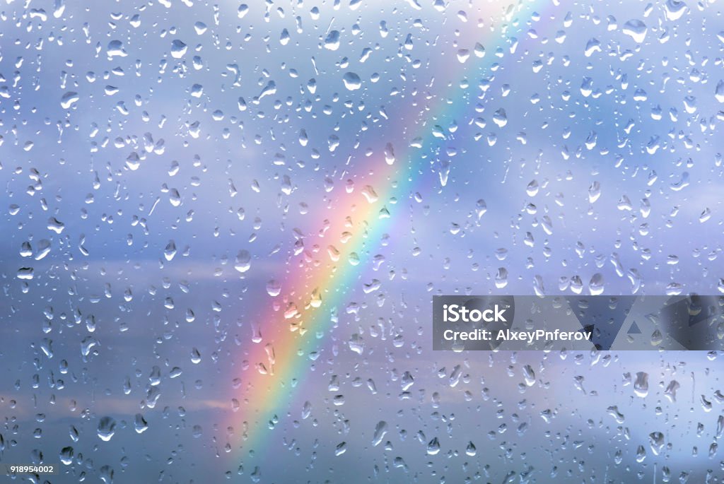 Rainbow through a window with drops after storm Rain Stock Photo