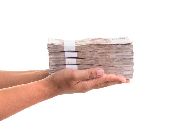 istock Hand giving Thai banknotes. Studio shot isolated on white 918954518