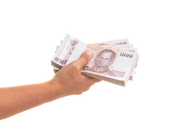 istock Hand giving Thai banknotes. Studio shot isolated on white background 918954690
