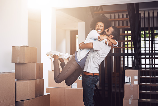 Cropped shot of an affectionate young couple moving into their new home