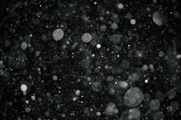 istock closeup background texture of snowflakes during a snowfall on a black background 918958514