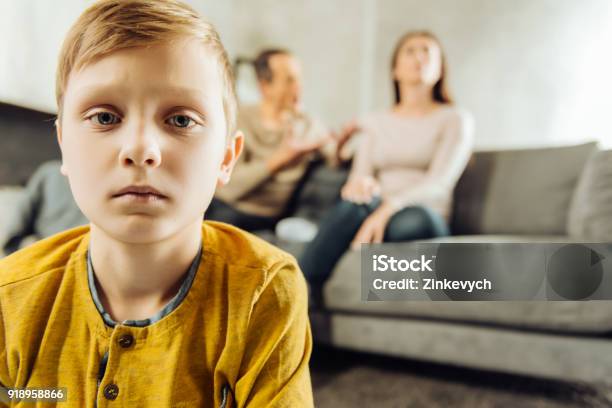 Little Boy Feeling Lonely While His Parents Quarrelling Stock Photo - Download Image Now