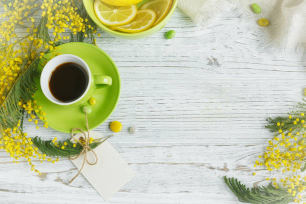 istock mimosa, lemon and coffee on light wooden background 918958930