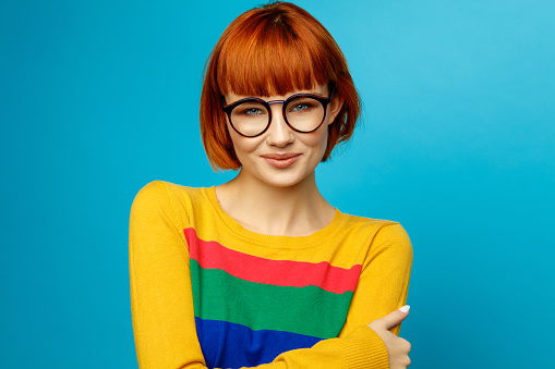 Portrait of beautiful smiling young woman with glasses