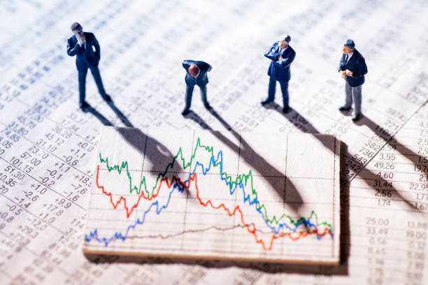 Businessmen looking at market charts stock photo