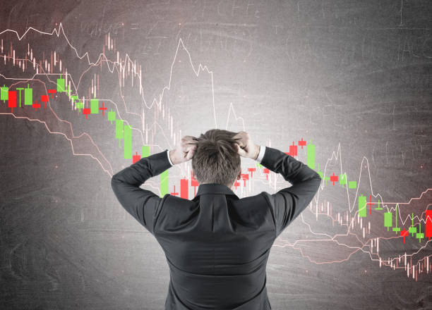 istock Businessman in terror, graphs blackboard 918975536