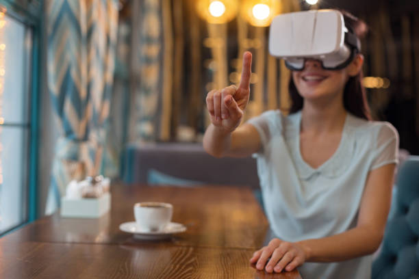 istock Enthusiastic energetic woman trying to touch VR object 918978200