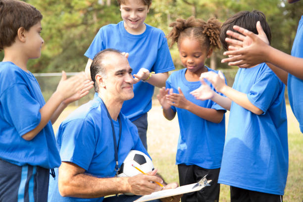istock Soccer team coach explains next play to his children's team. 918978818