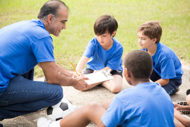 istock Soccer team coach explains next play to his children's team. 918978968