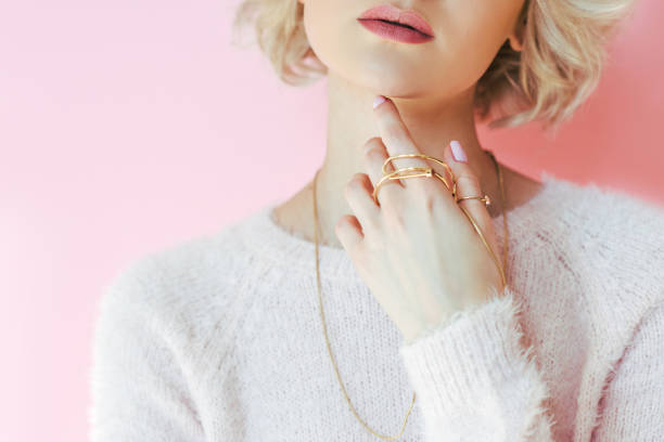 cropped shot of sensual young woman holding jewelry in hand isolated on pink cropped shot of sensual young woman holding jewelry in hand isolated on pink Charming stock pictures, royalty-free photos & images