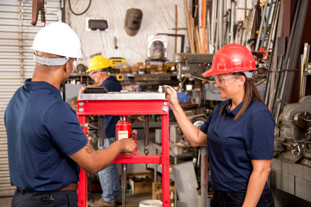 istock Industrial workers use equipment together in factory. 918985710