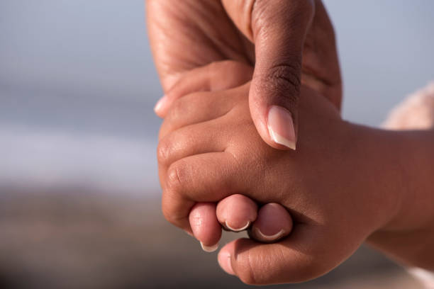 istock Mother's and child's hands together. 918985806