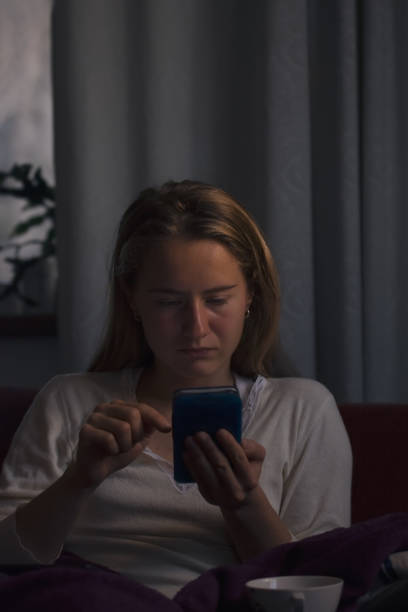 istock Young woman browsing the internet on mobile phone 918990042