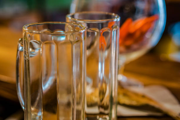 Mugs for beer and a glass for wine on the table.