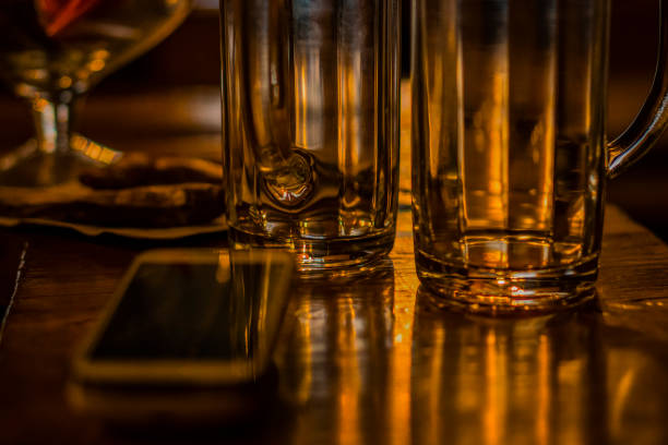 Neck of the bottle lying on the table surrounded by glasses
