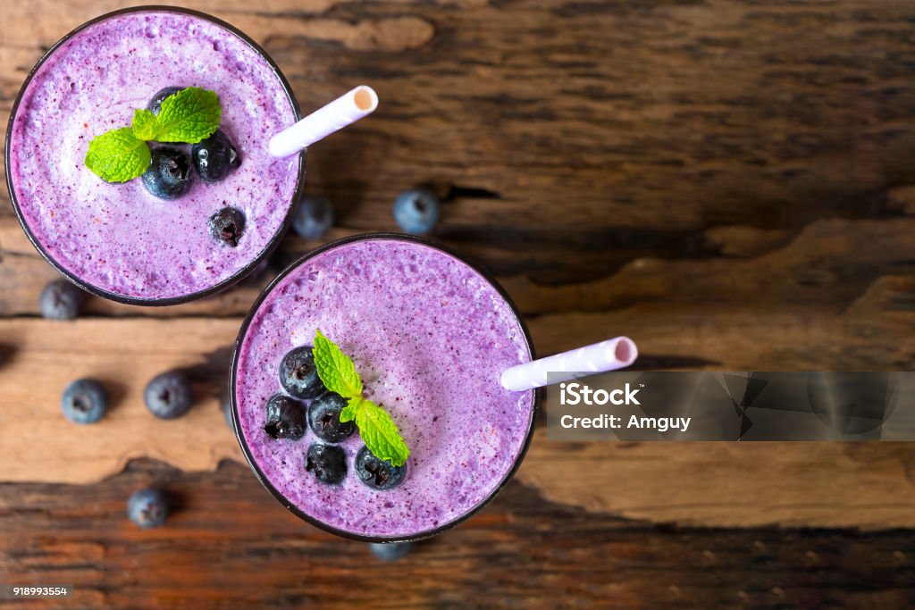 Blueberry smoothies Blueberry smoothies on wooden floor from top view. Smoothie Stock Photo