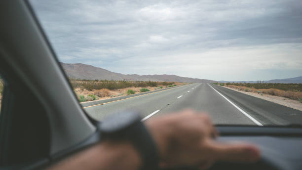 istock Driving a car on desert highway POV 918998764