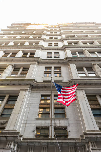 istock American flag with building behind. Perspective view. 919006132