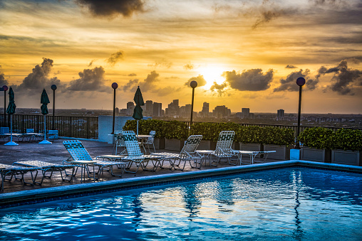 Sunset Pool Scene overlooking City Skyline