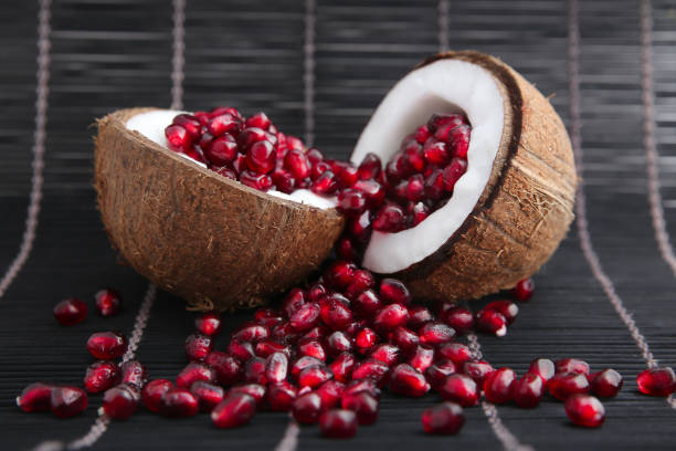 istock Garnet seeds in coconut shell in black wood background 919010212